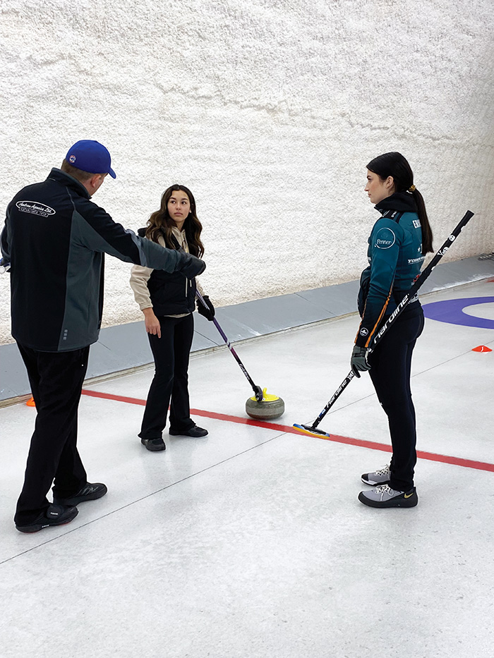 Cory Barkley and Rachel Erickson in a discussion with a young curler.”></a><br />
<p class=